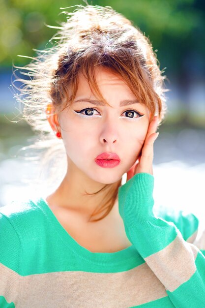 Close up portrait of young pretty girl have powerful emotions, surprised and shocked, having fun , wearing bright sweater and make up.