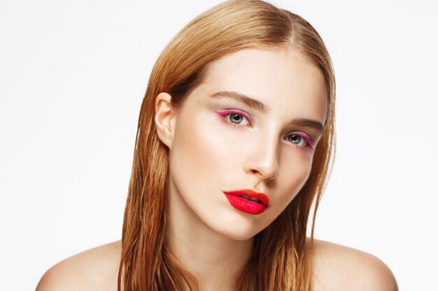 Close-up portrait of young sad woman with light make up.