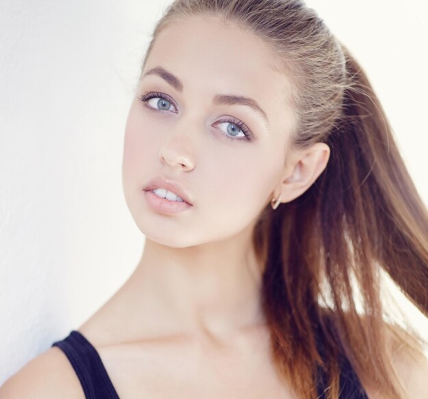 Close up portrait of young slim woman in black t shirt.