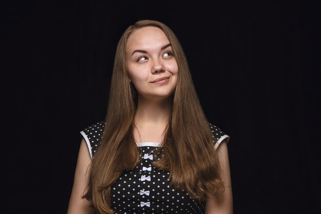 Close up portrait of young woman isolated. female model. Dreaming and smiling, hopeful and happy. Facial expression, human emotions concept.