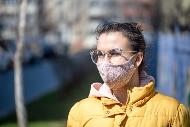 Close up portrait young woman in a mask during the pandemic coronavirus.