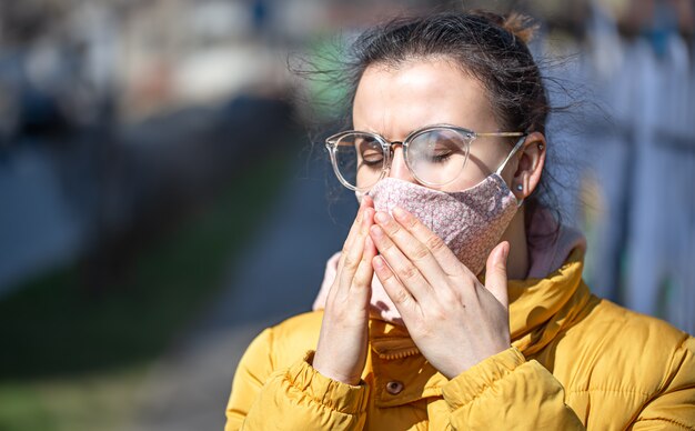 Close-up portrait young woman in a mask during the pandemic.