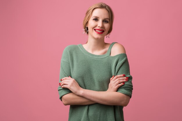 Close up portrait of young woman wearing a green sweater with red lips on pink