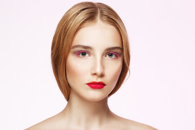 Close-up portrait of young woman with light make up.