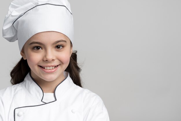 Close-up positive young chef smiling