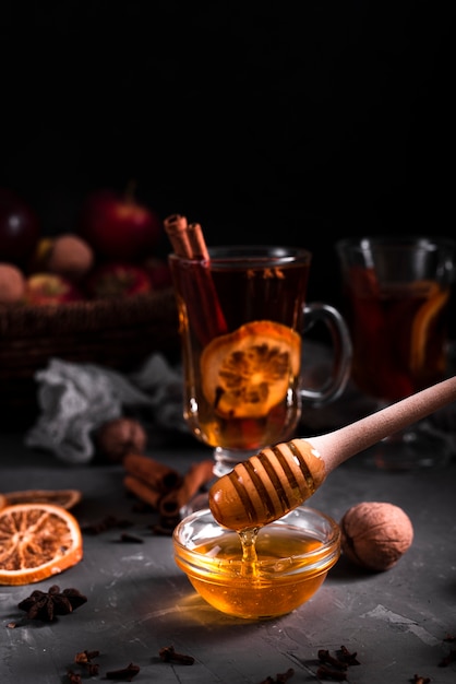 Free photo close-up of pouring honey and tea