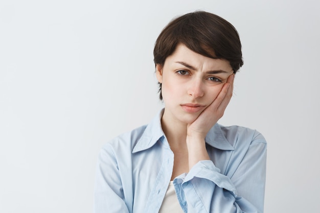 Close-up of pouting sad and disappointed girl looking reluctant, frowning upset