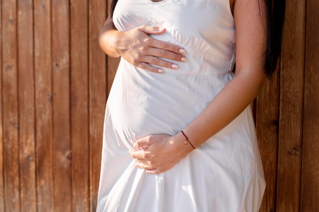 Close up pregnant woman holding belly