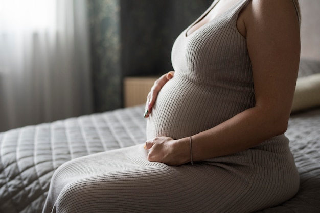 Close up pregnant woman sitting