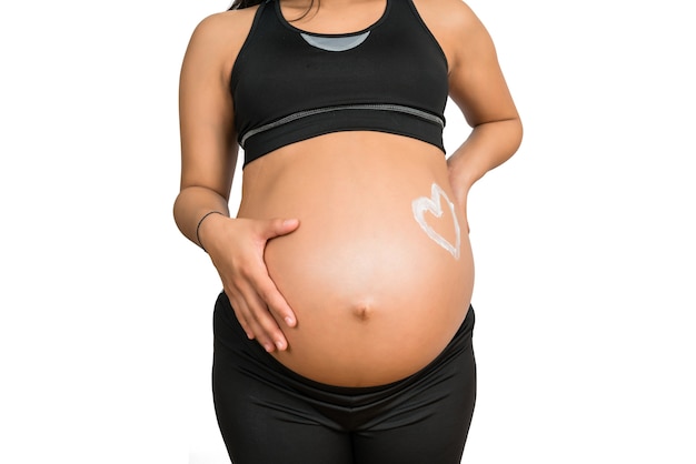 Close-up of pregnant woman with a drawn heart on belly