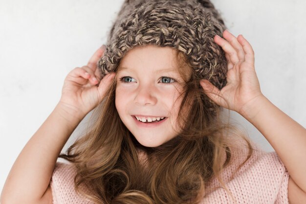 Close-up pretty little girl with winter hat