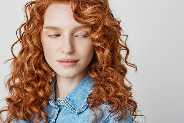 Close up of pretty redhead  girl with freckles Copy space.