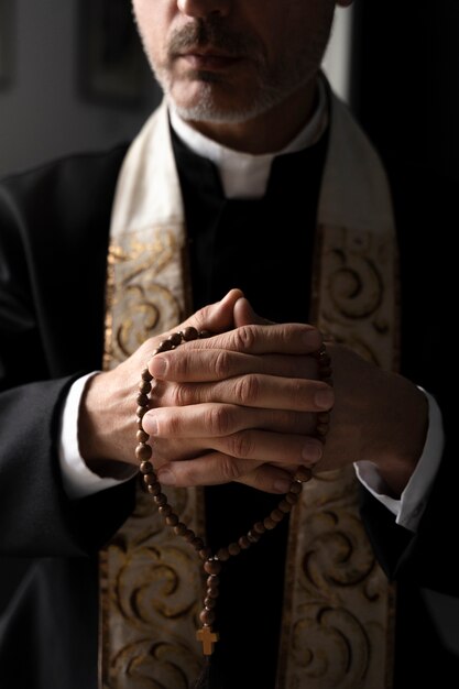 Close up priest holding crucifix