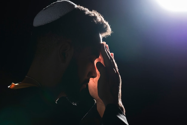 Close-up priest praying on full moon