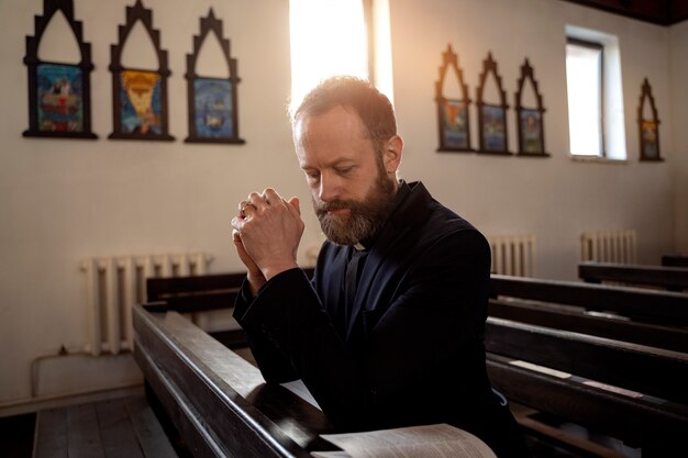 Close up on priest praying