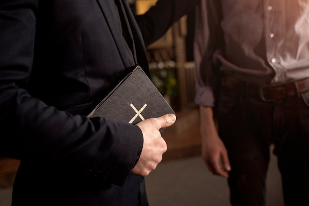 Close up on priest reading form the bible