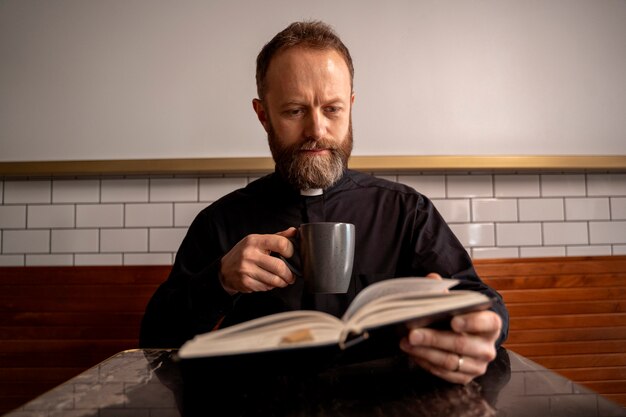 Close up on priest reading from bible