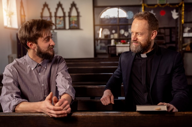 Close up on priest talking with person