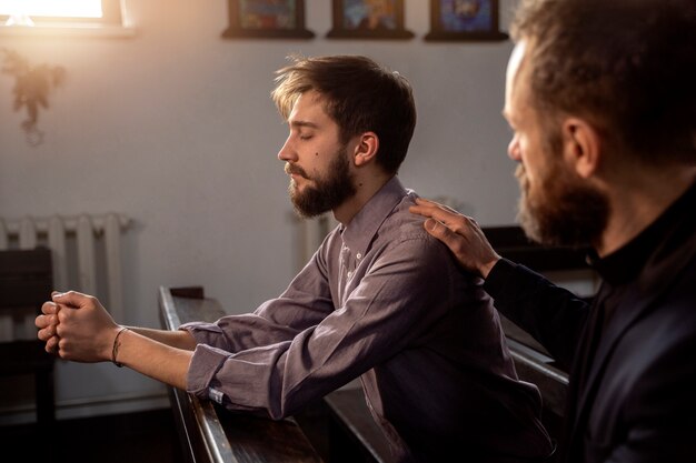 Close up on priest talking with person