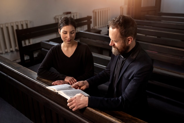 Close up on priest talking with person