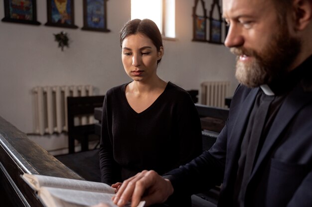 Close up on priest talking with person