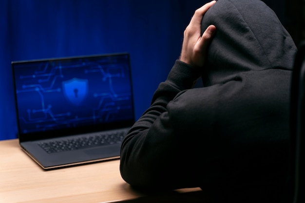 Free photo close up programmer at desk with laptop