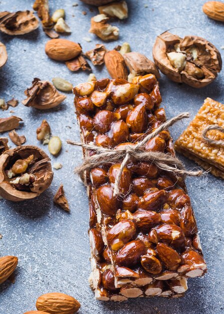 Close-up of proteins dried fruit bar tied with string with ingredients