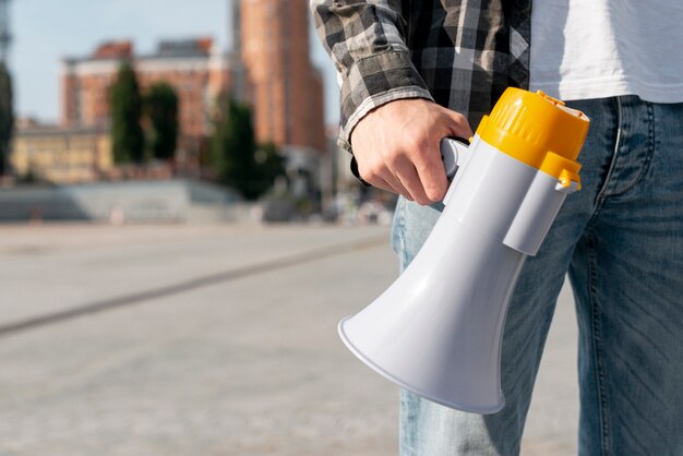 Close-up protester with megaphone for demonstration