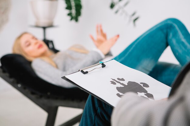 Close-up of psychologist diagnostic inkblot test rorschach of her patient lying on couch