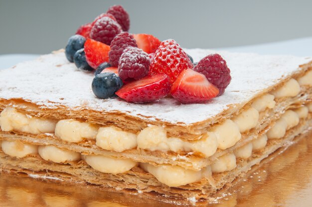 Close-up of puff pastry layer cake decorated with fresh berries