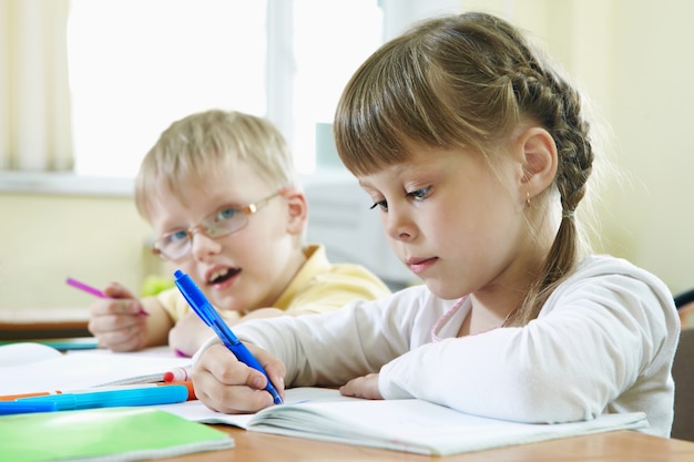 Close-up of pupils doing homework