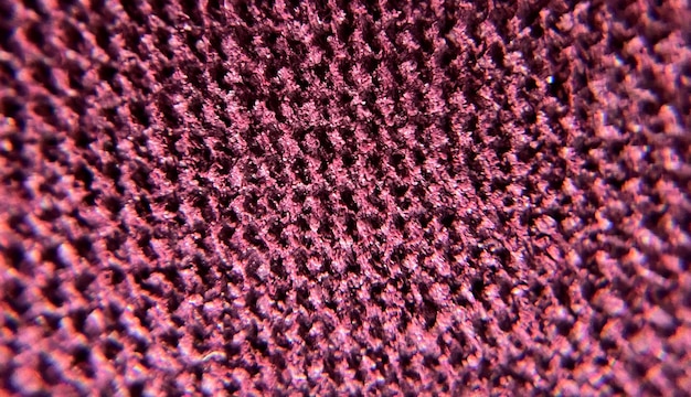 A close up of purple texture fabric with a small pattern of small squares