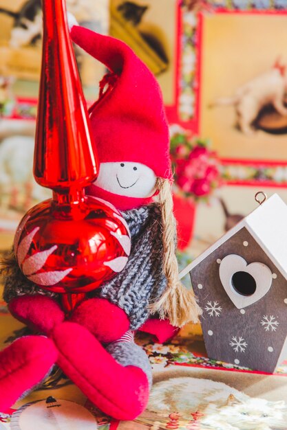 Close-up of rag doll and bird house