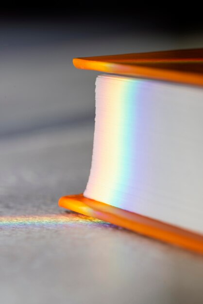 Close-up of rainbow sunlight on closed book