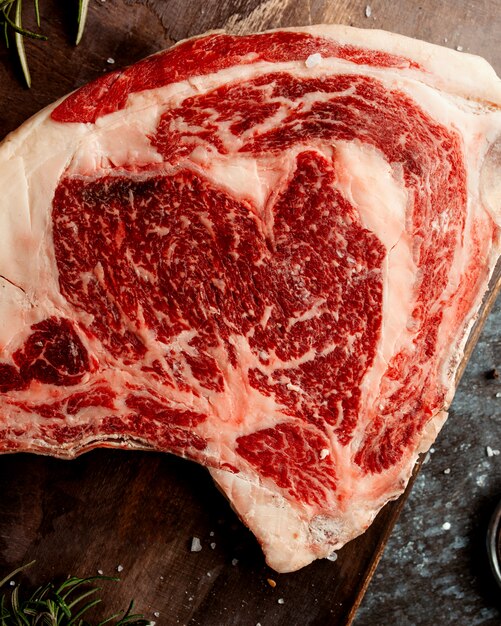 Close up of raw lamb meat placed on wooden board