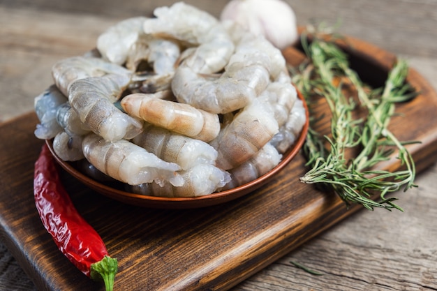 Close up of raw shrimps on wooden background.