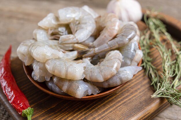 Close up of raw shrimps on wooden background.