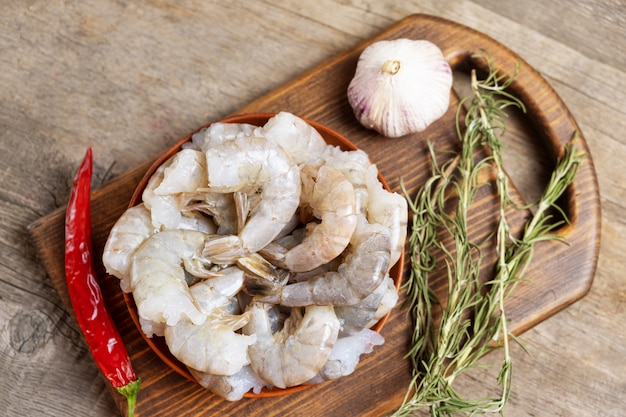 Close up of raw shrimps on wooden background.