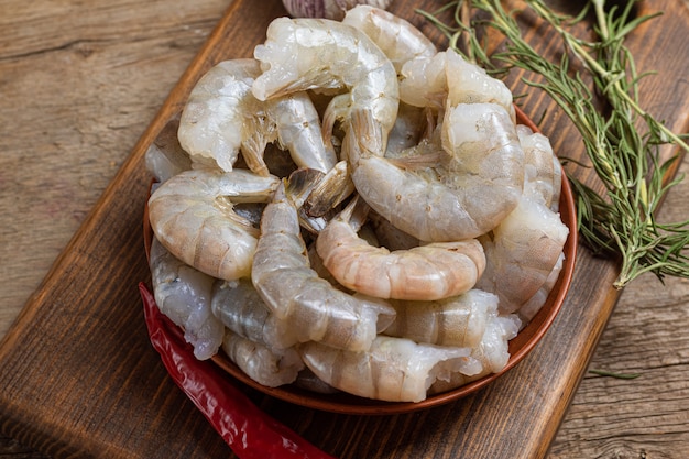 Close up of raw shrimps on wooden background