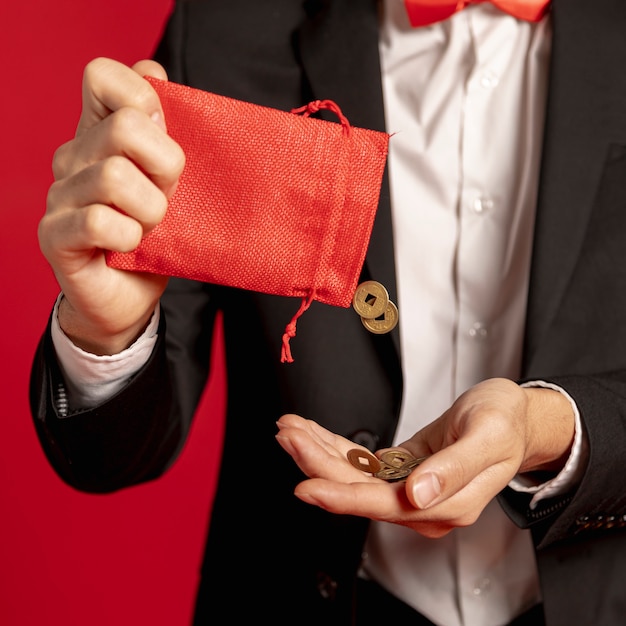 Close-up of red bag with golden coins for chinese new year