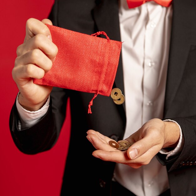 Close-up of red bag with golden coins for chinese new year