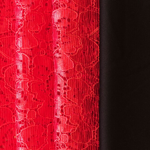 Close-up of red lace and black fabric background