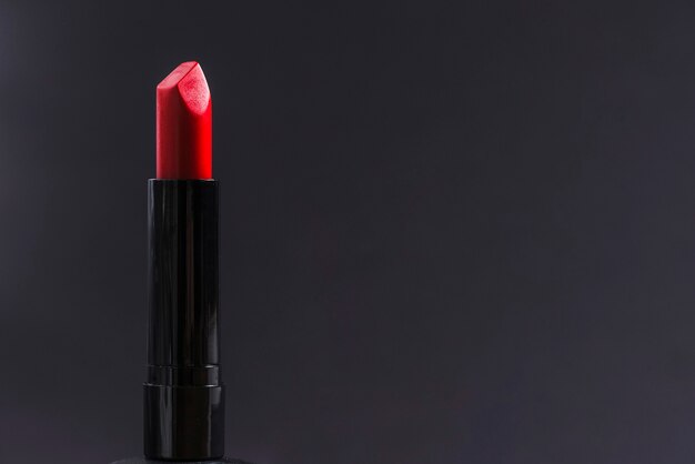 Close-up of red lipstick against black background