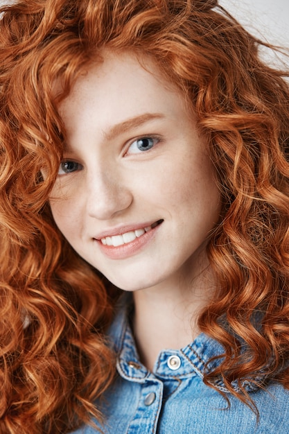 Free photo close up of redhead beautiful girl with freckles smiling .