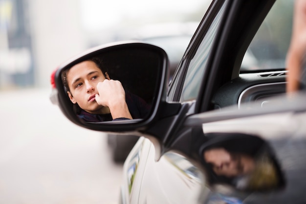 Close-up reflexion of man in the mirror