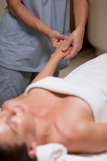 Close up relaxed woman getting hand massage