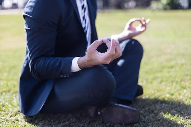 Close-up of relaxed worker in the lotus position