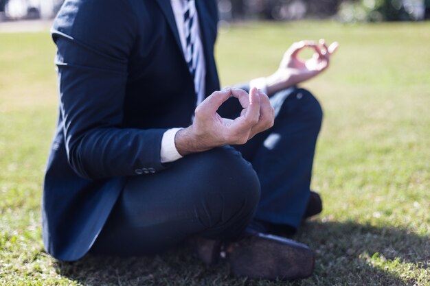 Close-up of relaxed worker in the lotus position