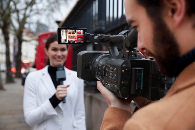 Close up reporters with video camera