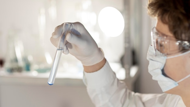 Close-up researcher holding tube